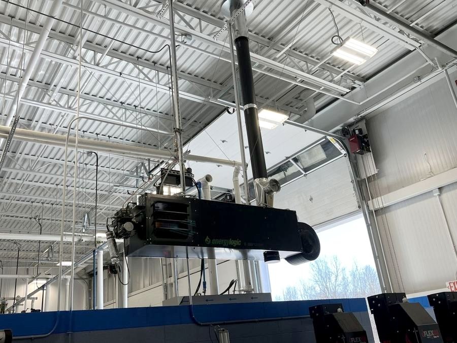 An EnergyLogic waste oil heater installed overhead in a shop by Total Tool