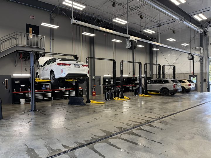 Bays with two-post lifts, workstations and overhead reels